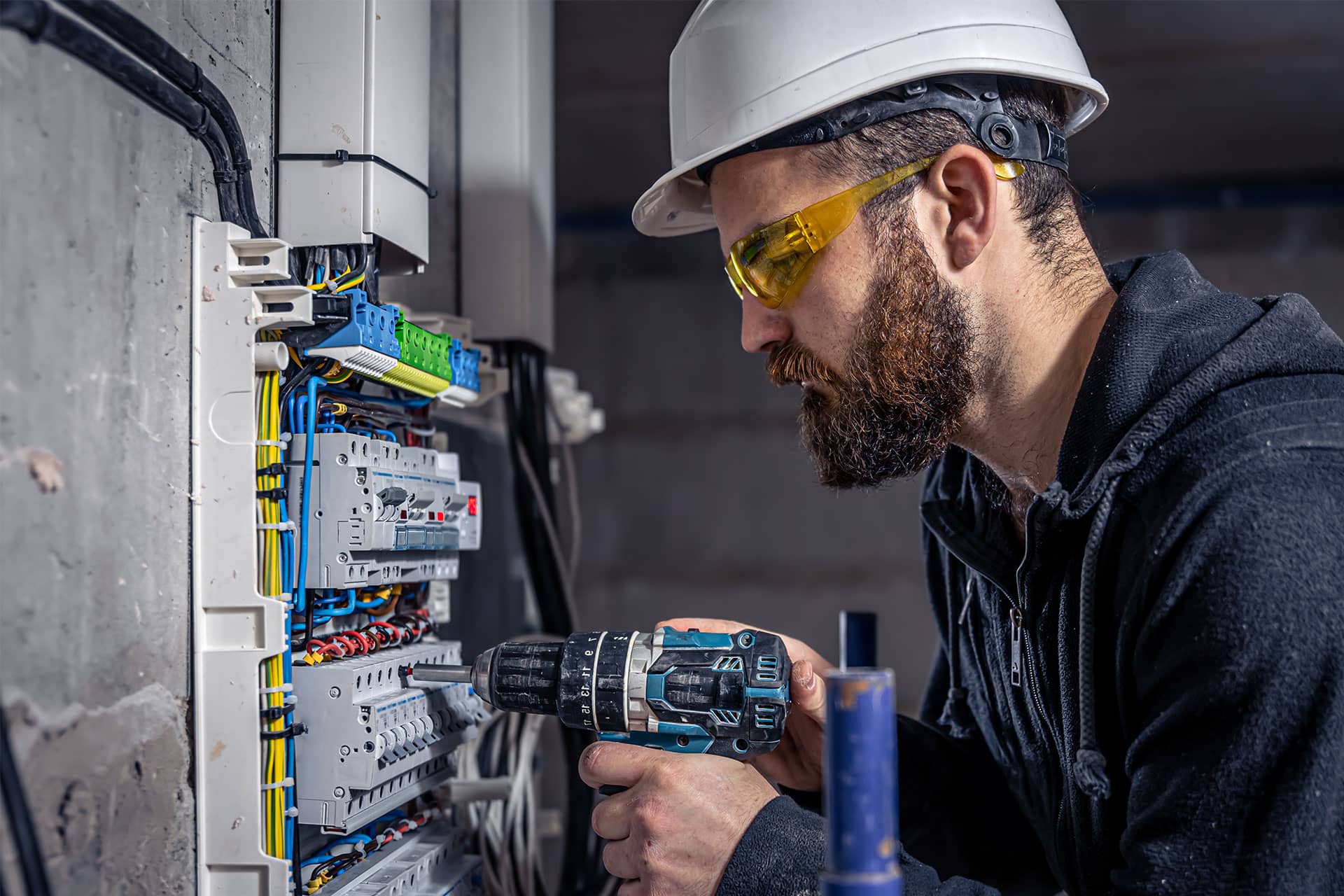 A male technician works in a a switchboard