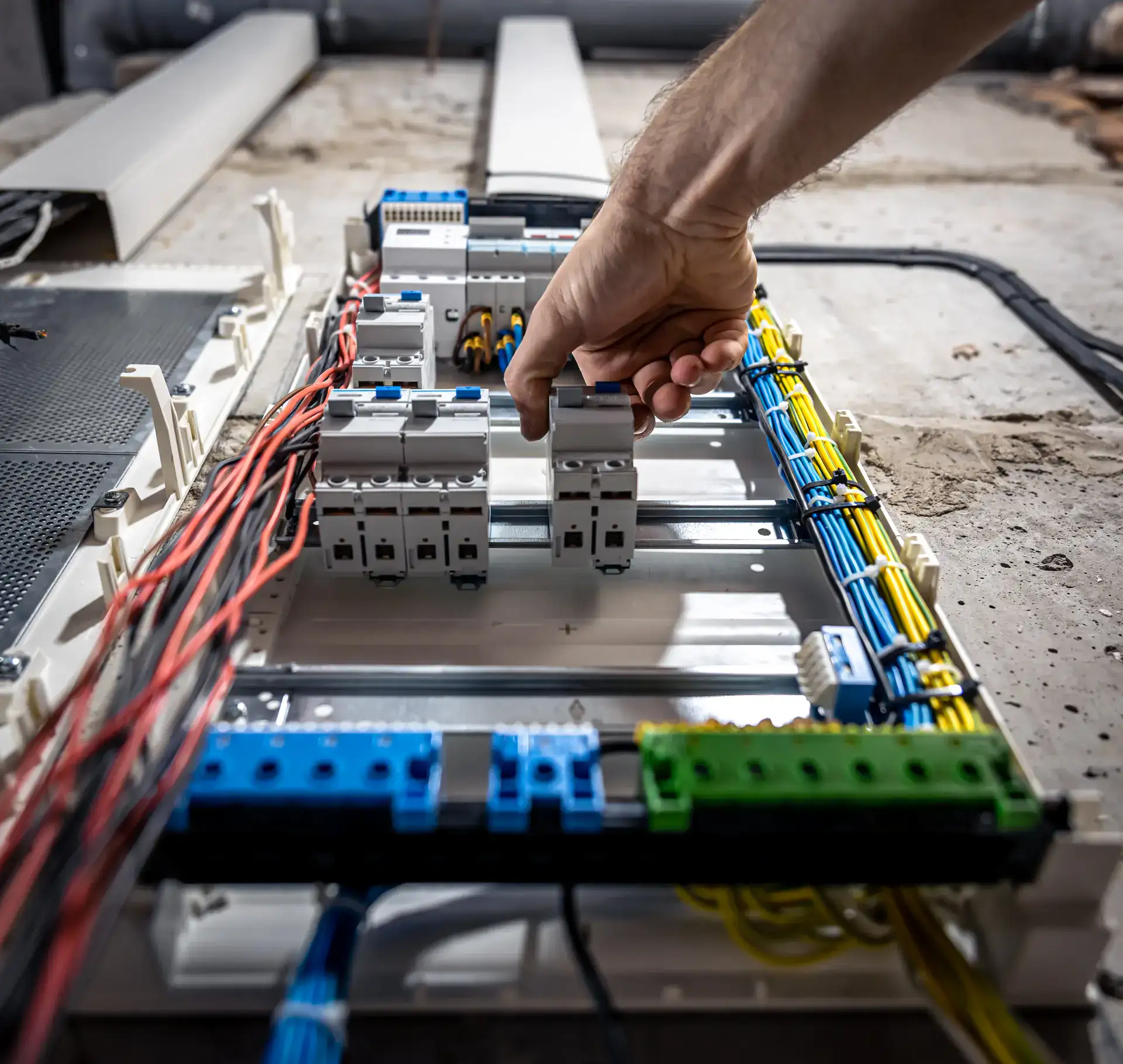 A zoomed image of a hand turning on the plank of a electric station